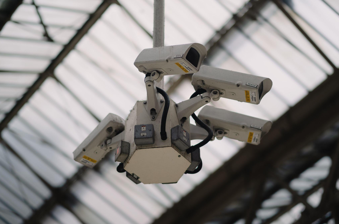 Cluster of four cameras mounted on ceiling; image by Levi Meir Clancy, via Unsplash.com.