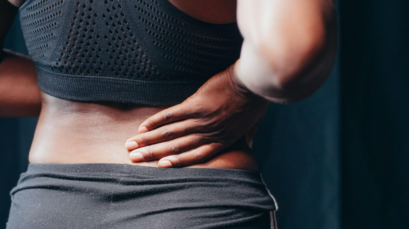 Woman with back pain; image by Kindel Media, via Pexels.com.