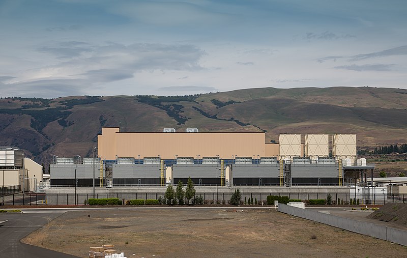 A squat, nondescript building, backed by arid-looking low mountains.