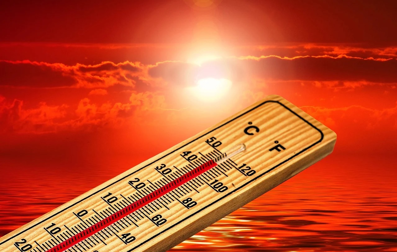 A thermometer reads 111°F or 45°C against the backdrop of the sun in a burning red sky.