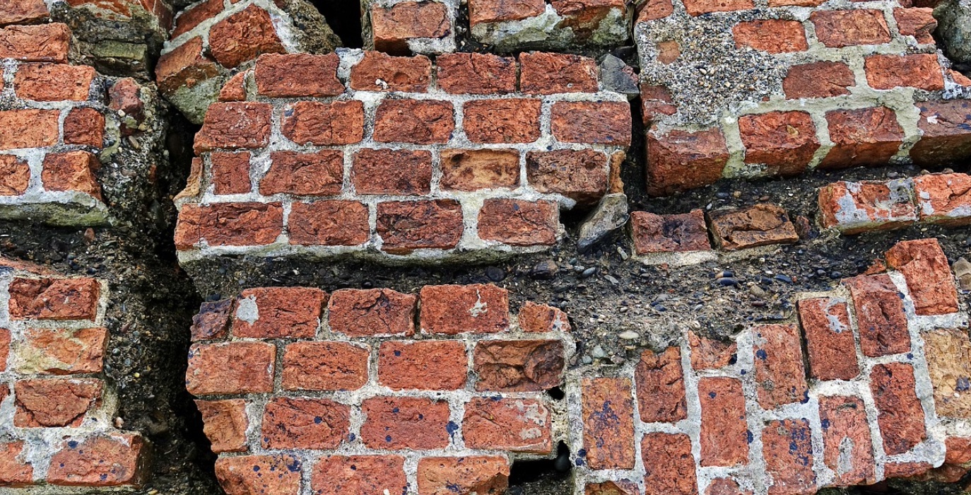 Broken brick wall; image by aitoff, via Pixabay.com.