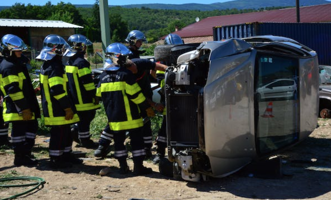 Firefighters examing wrecked car; image by Ulrick Trappschuh, via Pexels.com.