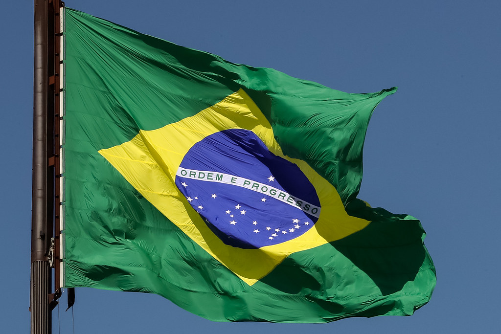 A flag with a green background, yellow central diamond, and blue central circle.