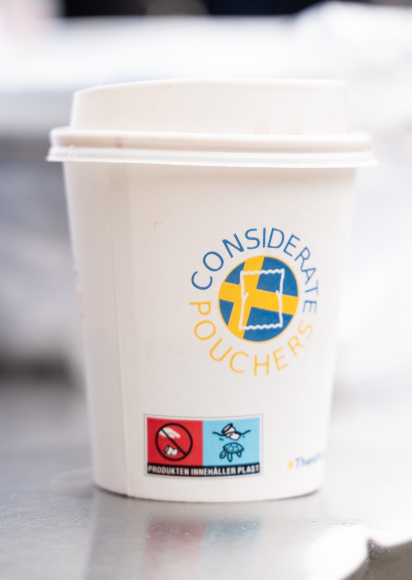Cup of coffee with Considerate Pouchers logo shared during fika; image courtesy of Considerate Pouchers.