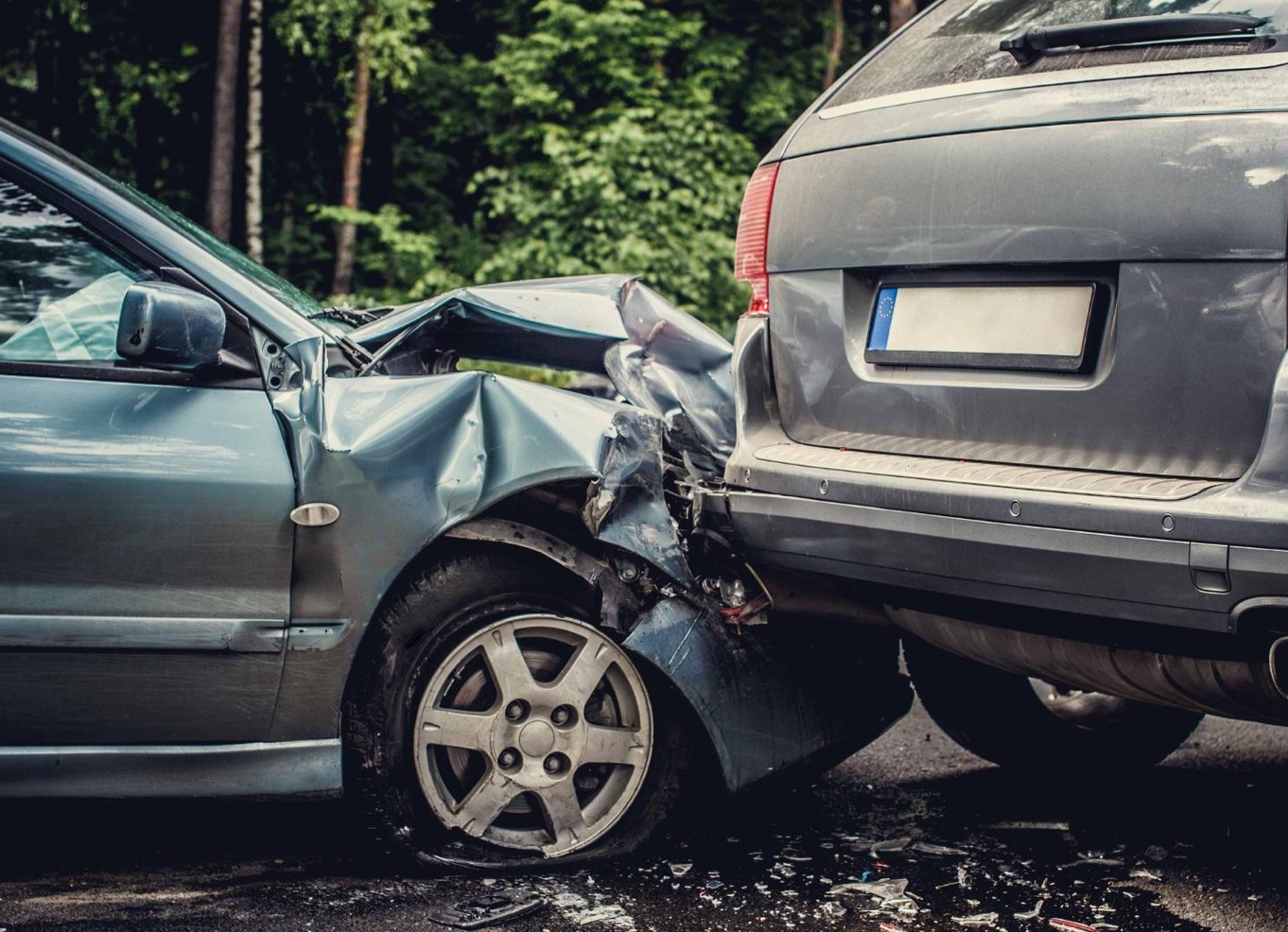 Teal car hitting grey car from behind; image by fxquadro, via Freepik.com.