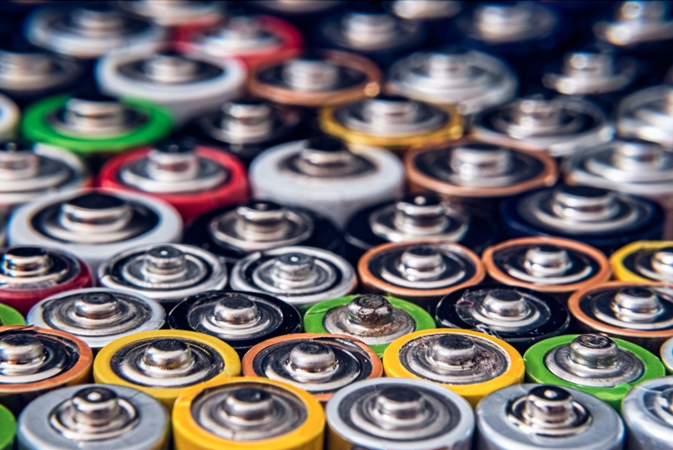 Upclose shot of tops of batteries; image by Roberto Sorin, via Unsplash.com.