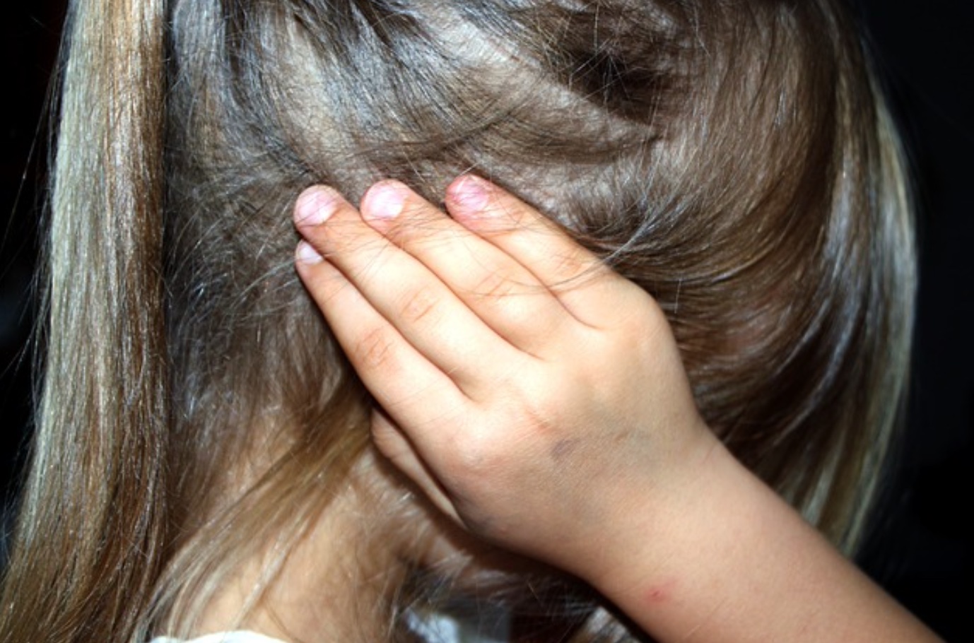 Scared little girl with hands over her ears; image by Counselling, via Pixabay.com.