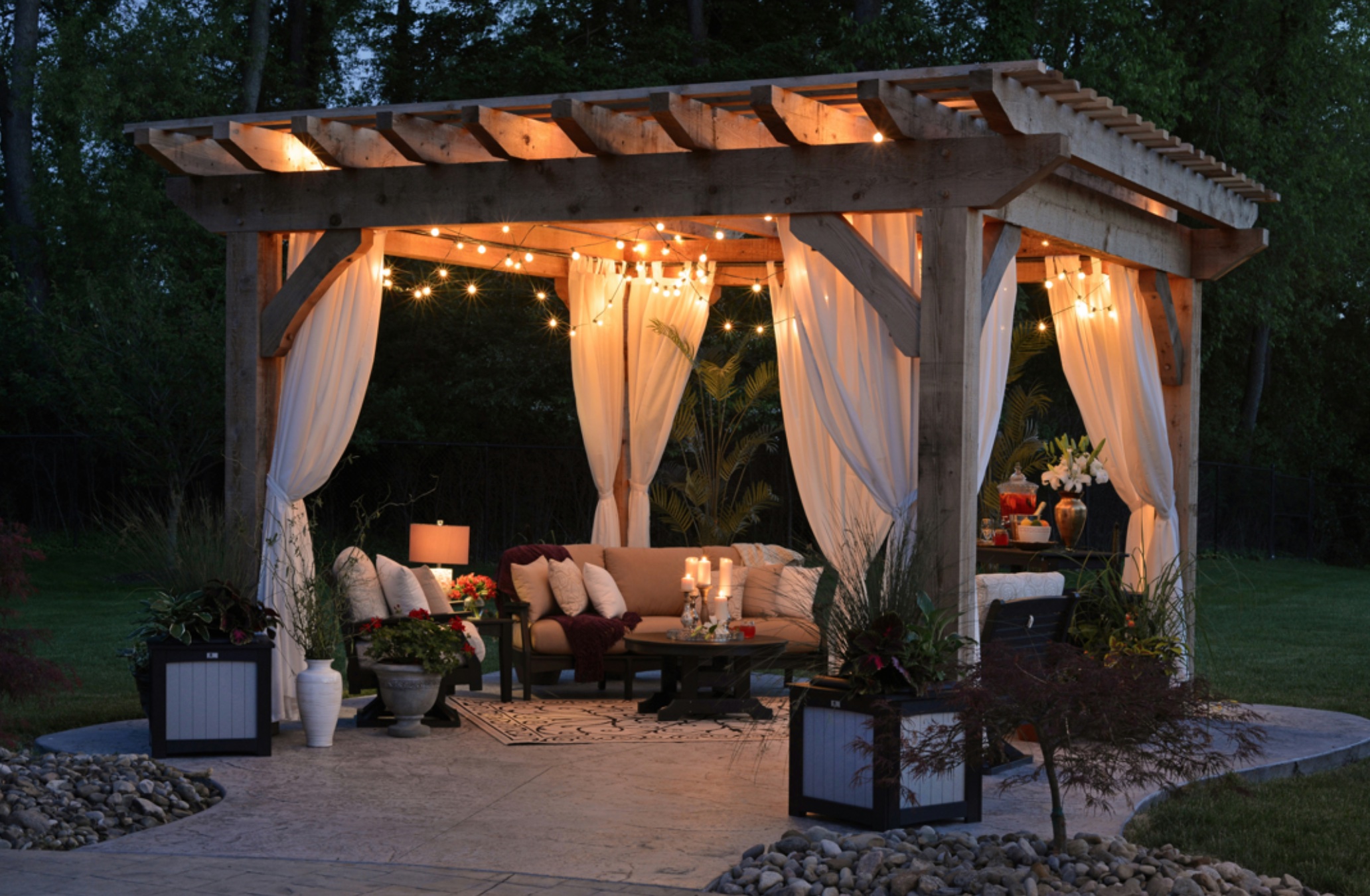 Gazebo with curtain and string lights at night; image by Randy Fath, via Unsplash.com.