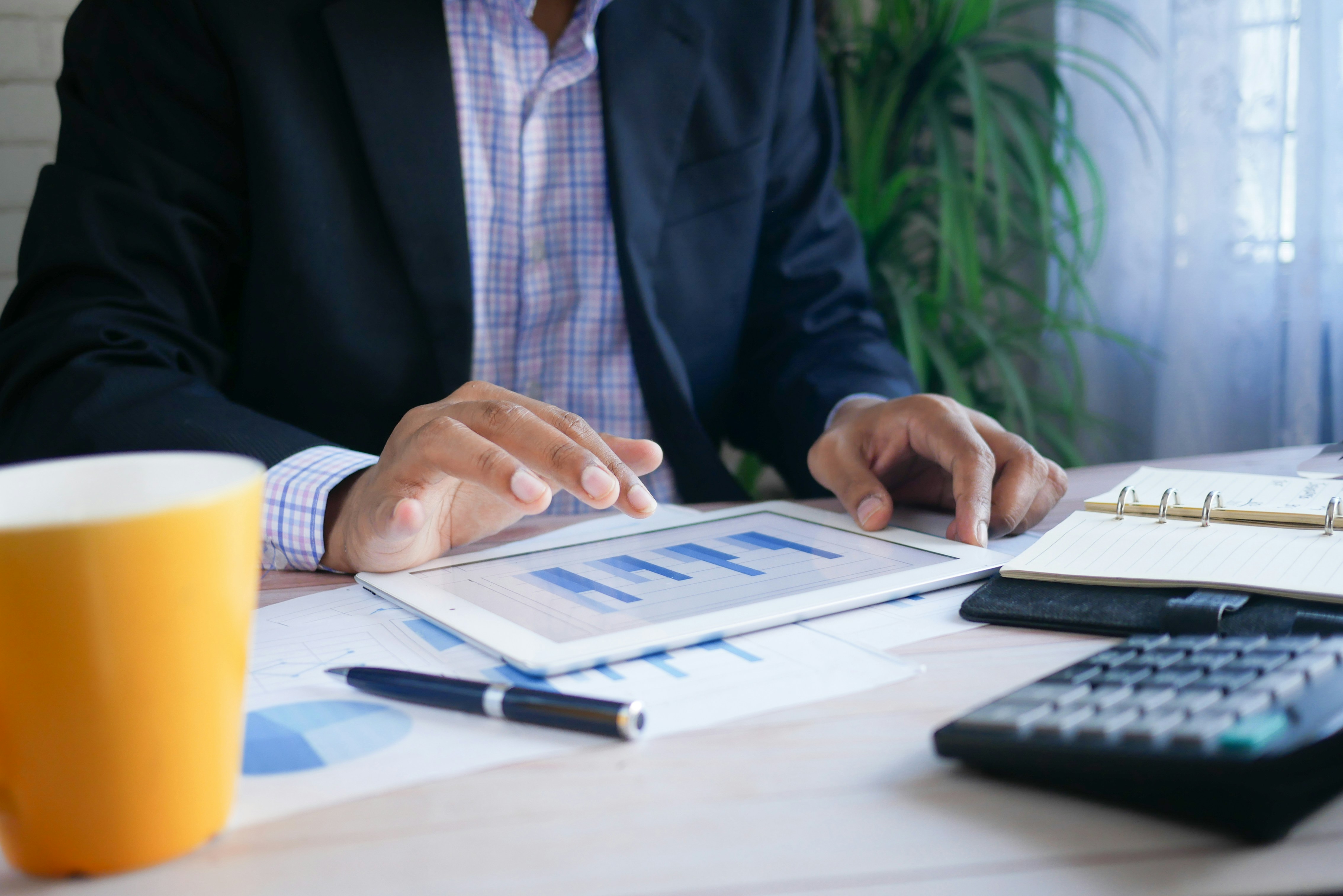 Man reviewing financial reports; image by Towfiqu Barbhuiya, via Unsplash.com.