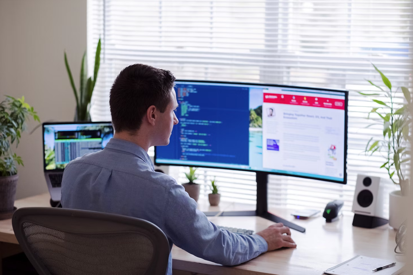 Man in dress shirt at desk with computer monitor; image by Luke Peters, via Unsplash.com.