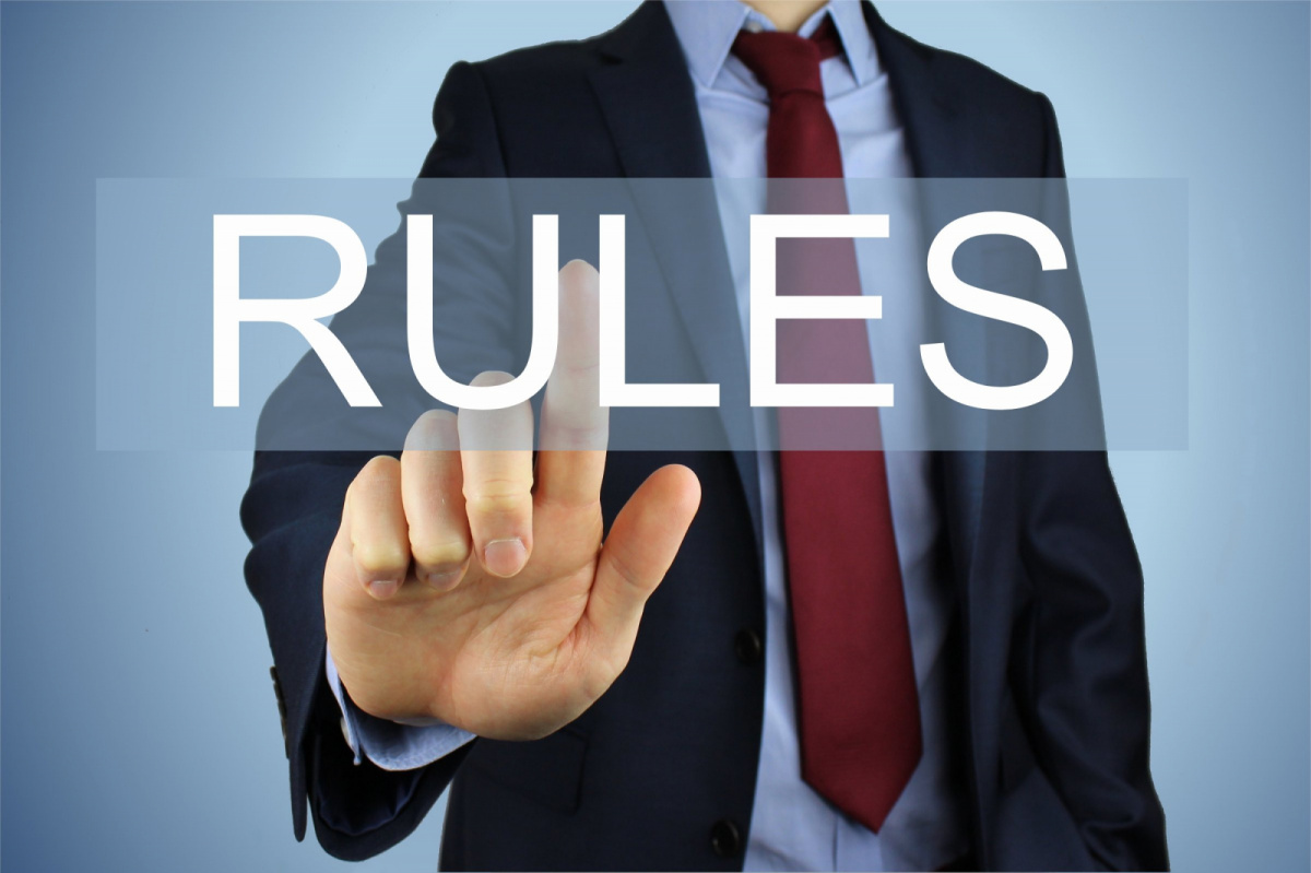 Man in suit with finger on the word "rules"; image by Nick Youngson CC BY-SA 3.0 Pix4free