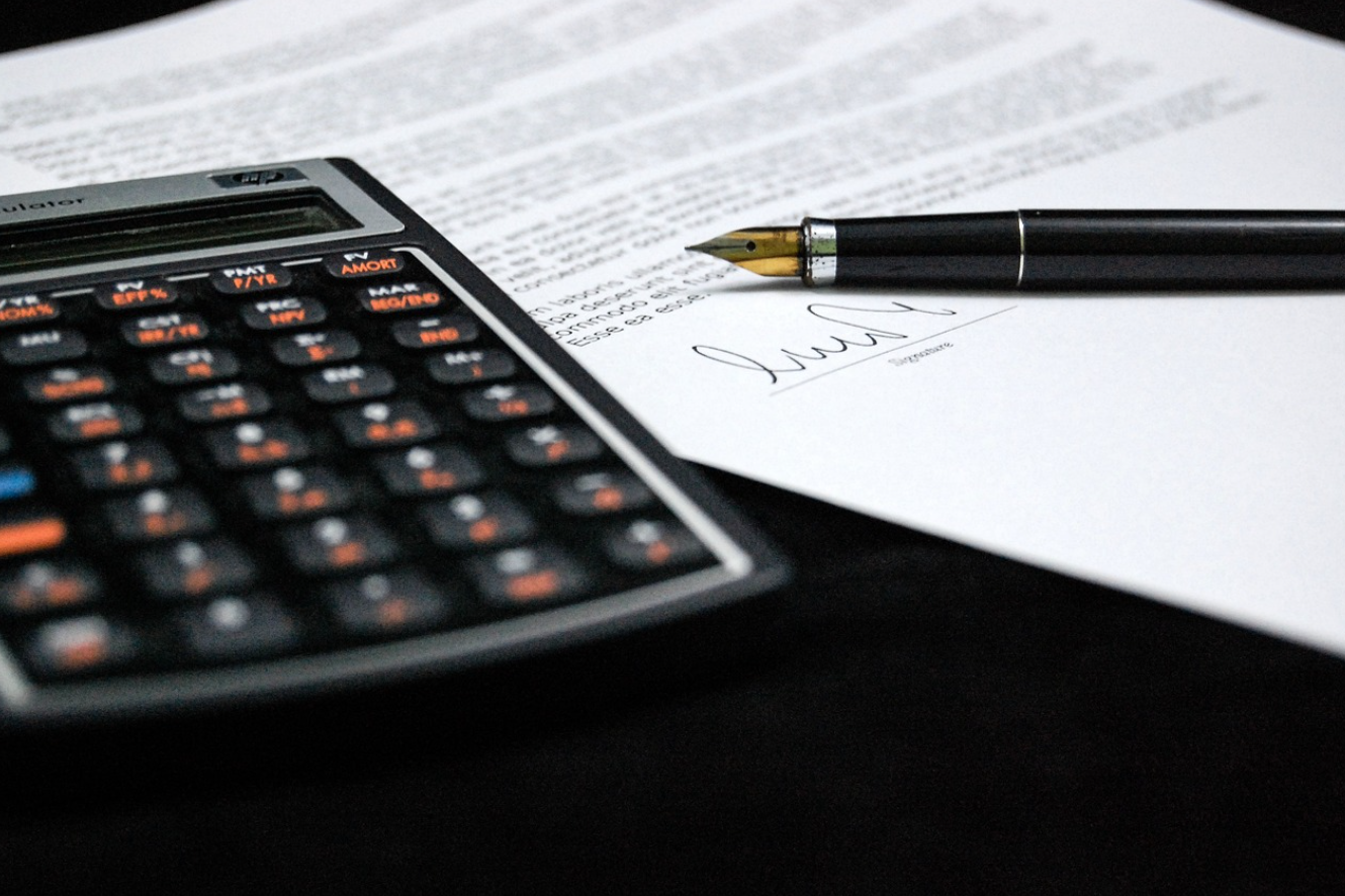 Contract, calculator, and pen; image by Jarmoluk, via Pixabay.com.