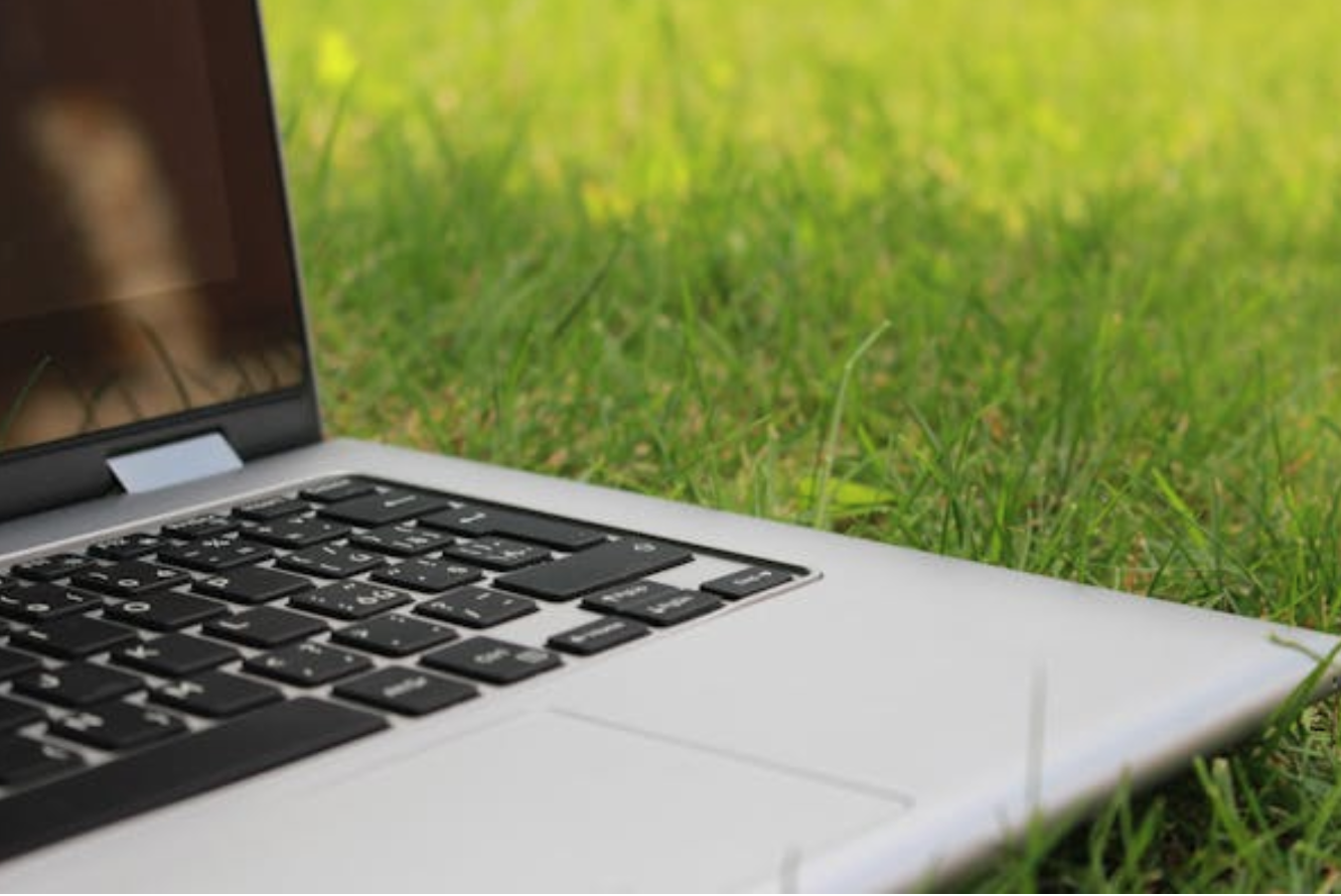 Open laptop on green grass; image by StockSnap, via Pixabay.com.