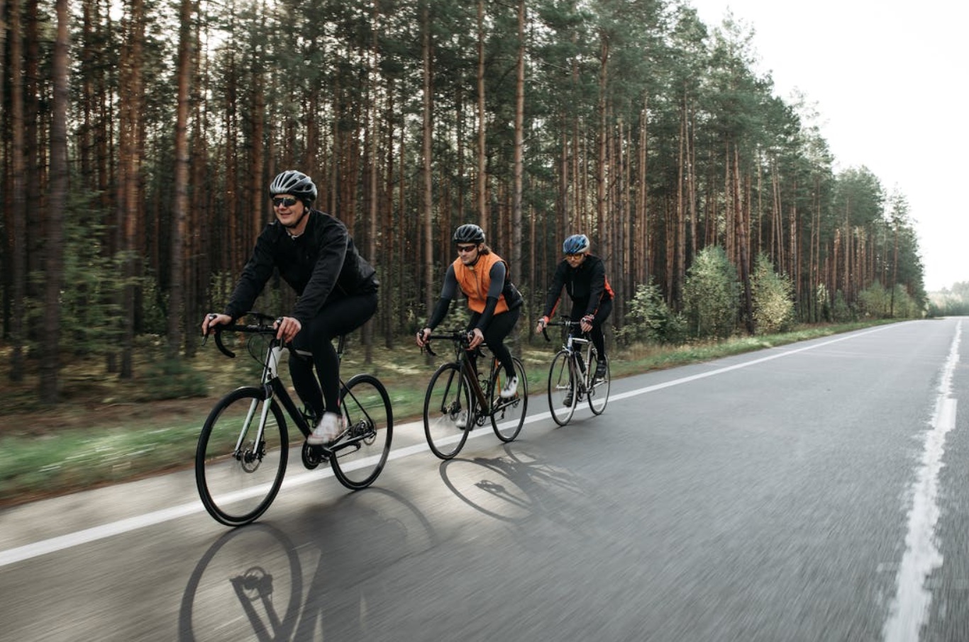 Three people biking on the road; image by Pavel Danilyuk, via Pexels.com.
