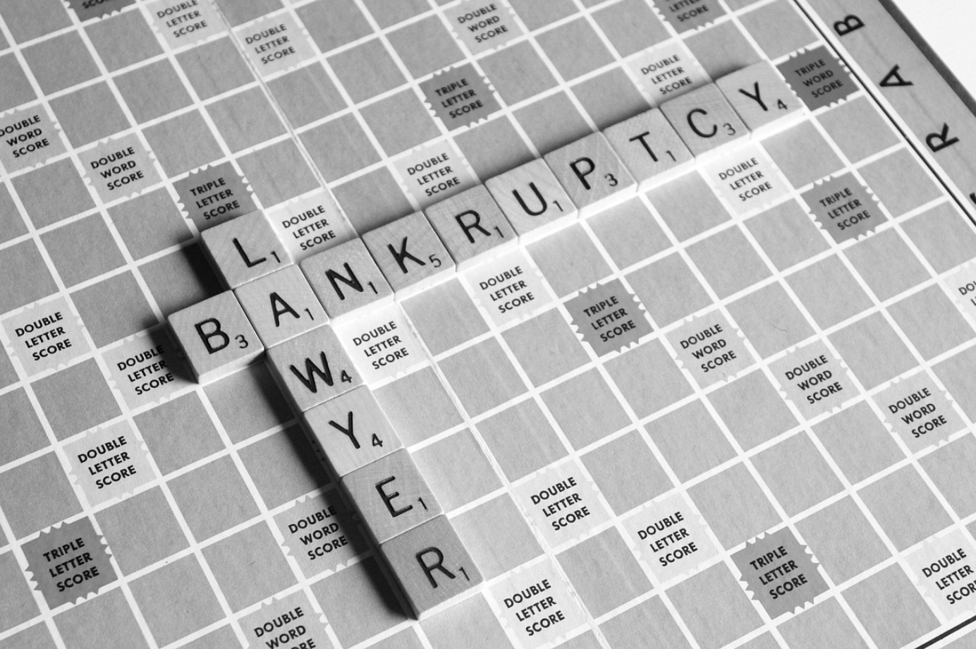 Greyscale photo of Scrabble board wih Bankruptcy Lawyer spelled out in tiles; image by u_ukgjgf0syq, via Pixabay.com.