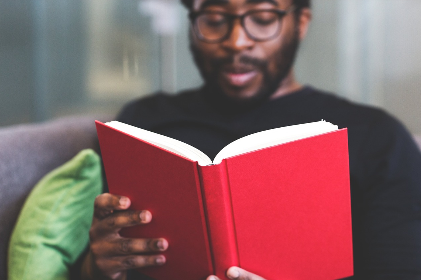 Man reading a book; image by StockSnap, via Pixabay.com.