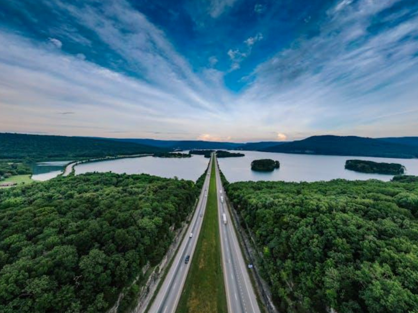 Road between trees; image by Kelly, via Pexels.com.