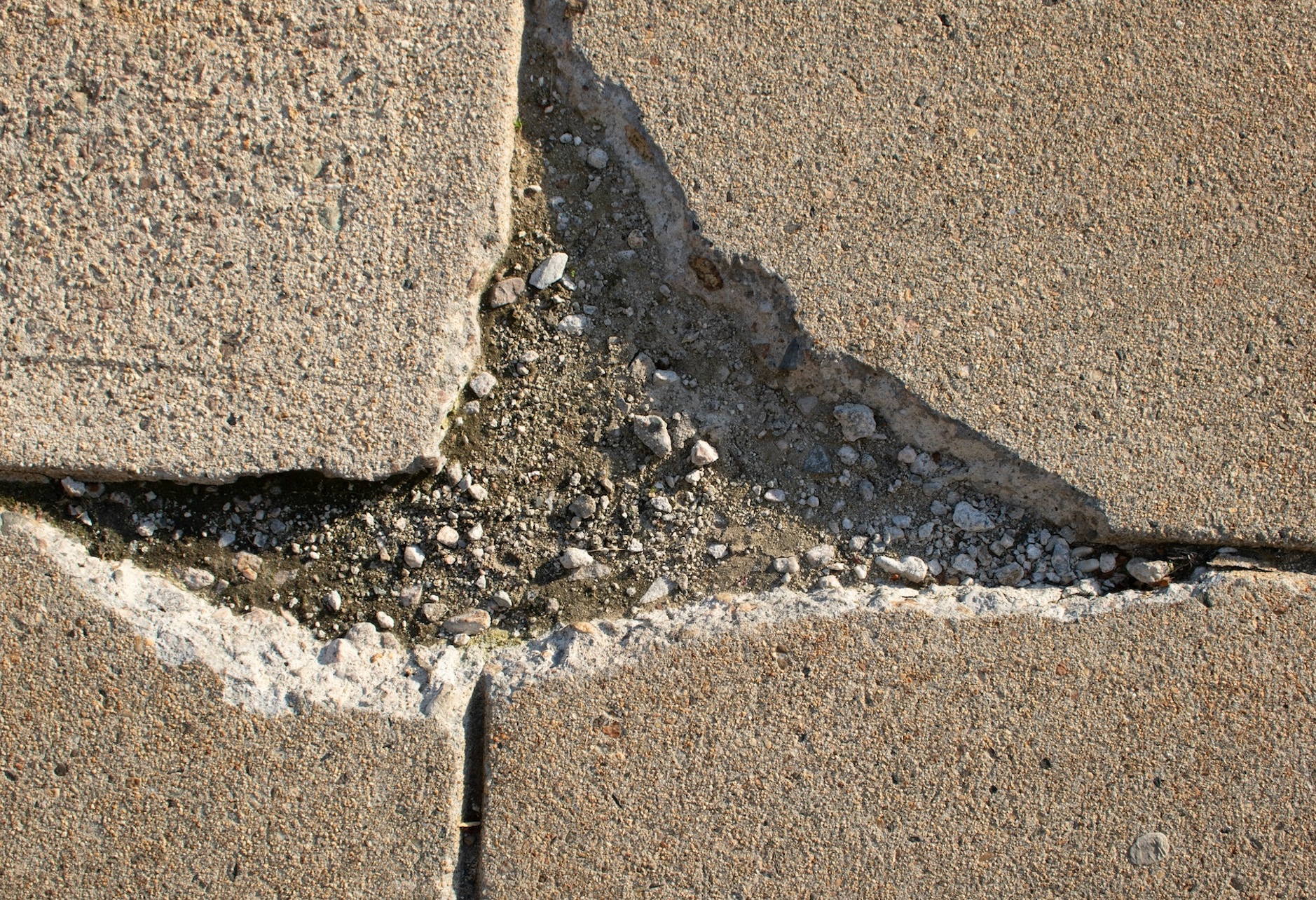 Broken sidewalk; image by Zoshua Colah, via Unsplash.com.