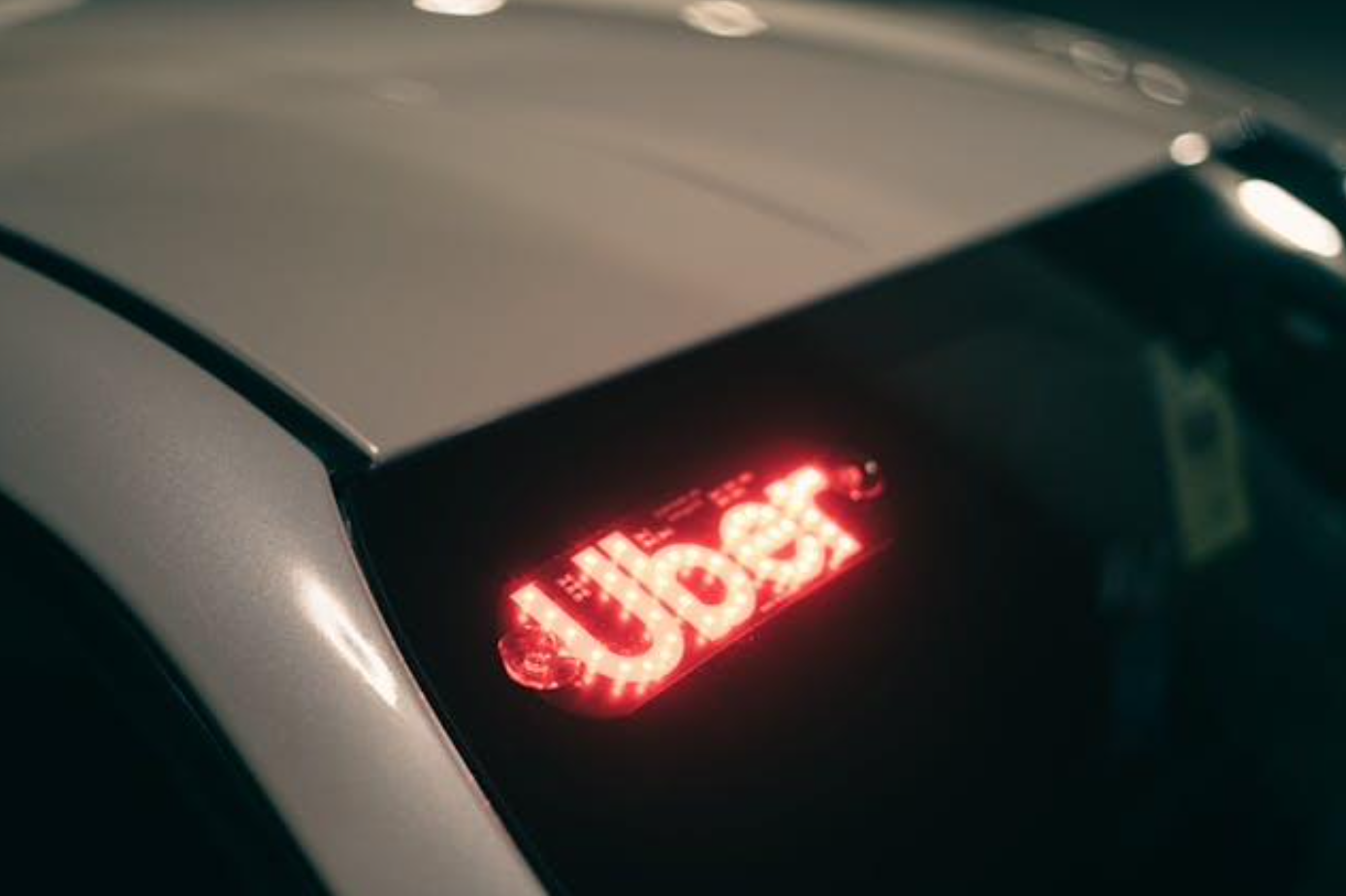 A car with the word Uber on it; image by Erik Mclean, via Pexels.com.