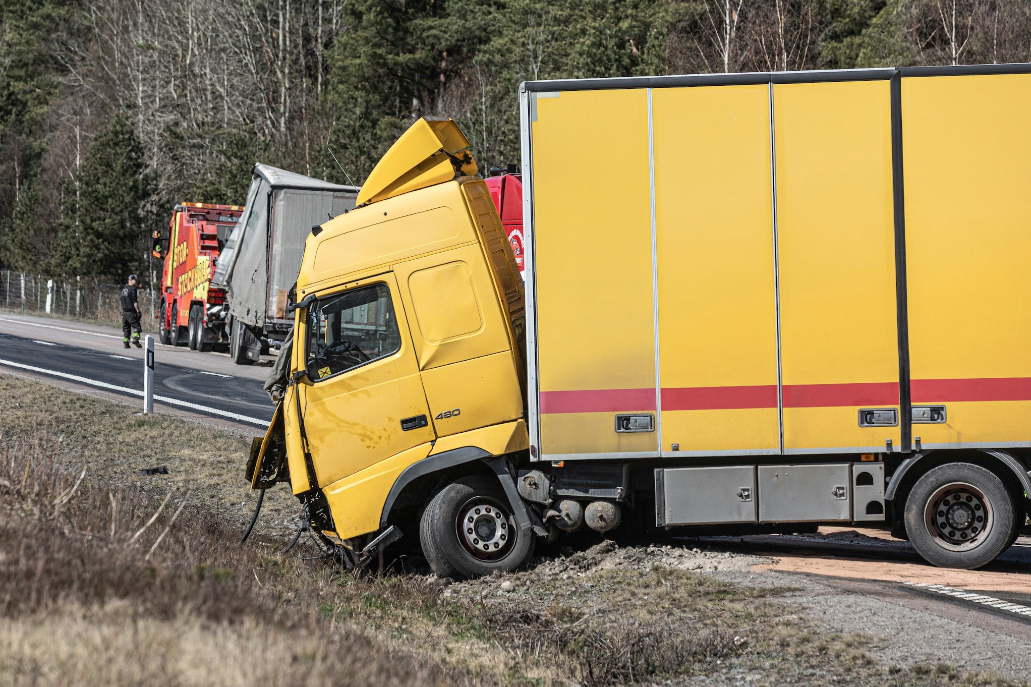 Yellow semi in roadside accident; image by Carl Tronders, via Unsplash.com.