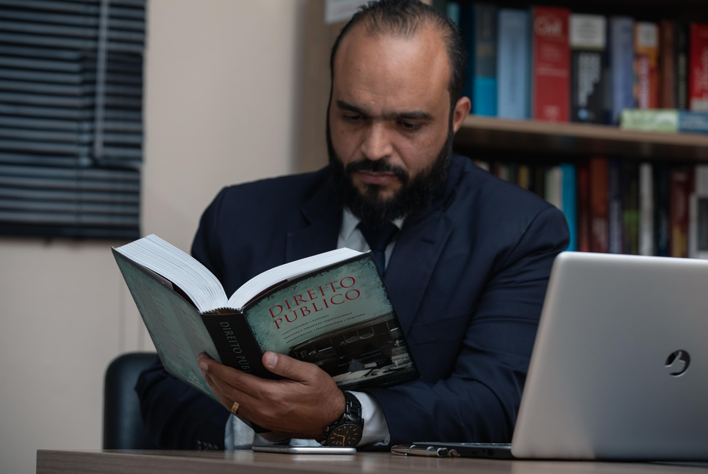 Lawyer consulting book; image by advogadoaguilar, via Pixabay.com.