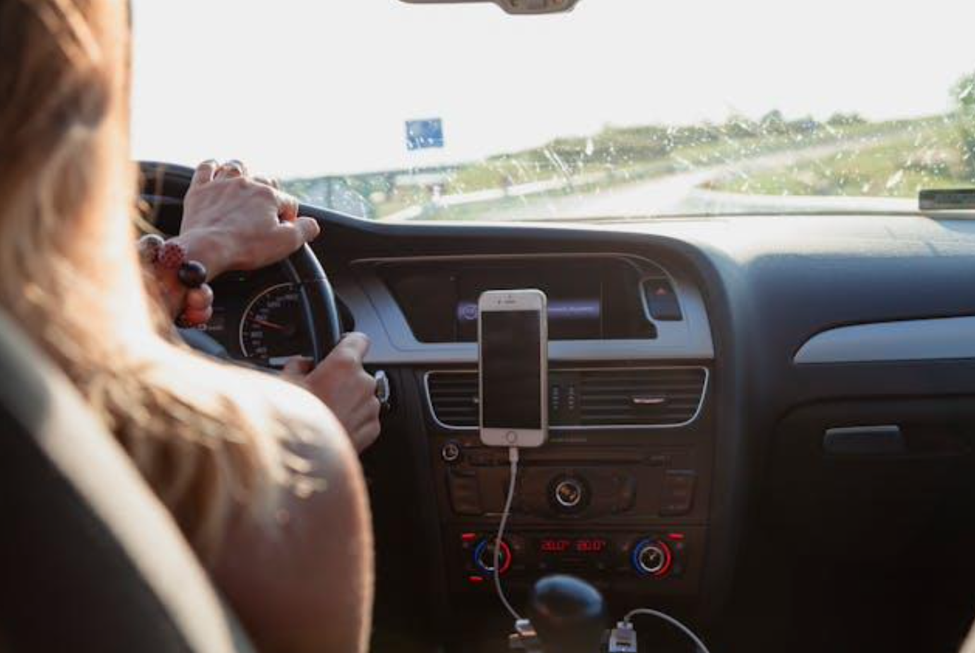 Woman driving; image by Peter Fazekas, via Pexels.com.