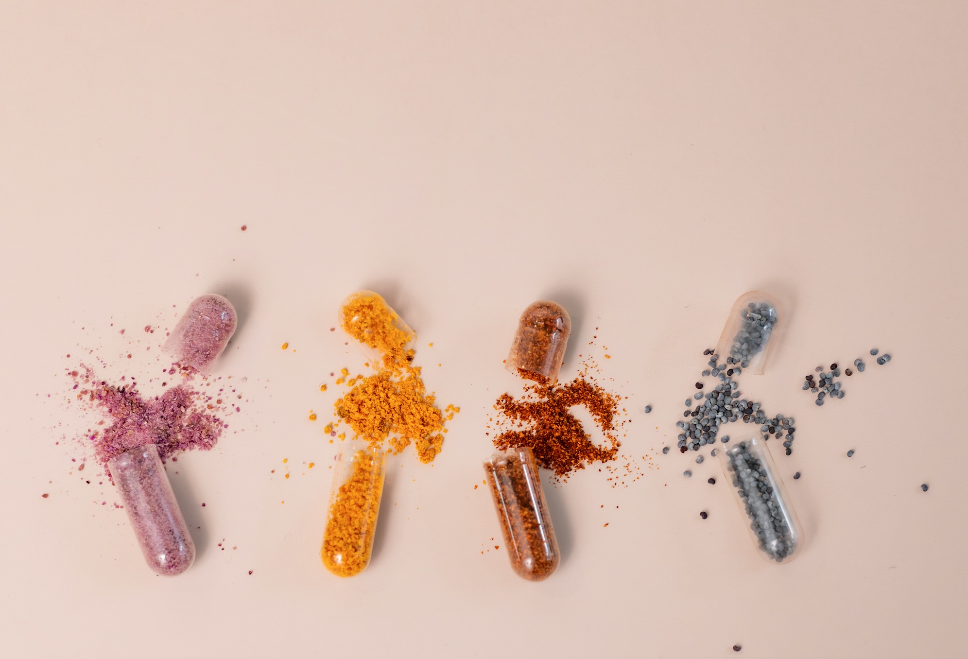 A group of pills sitting next to each other; image by laura adai, via Unsplash.com.