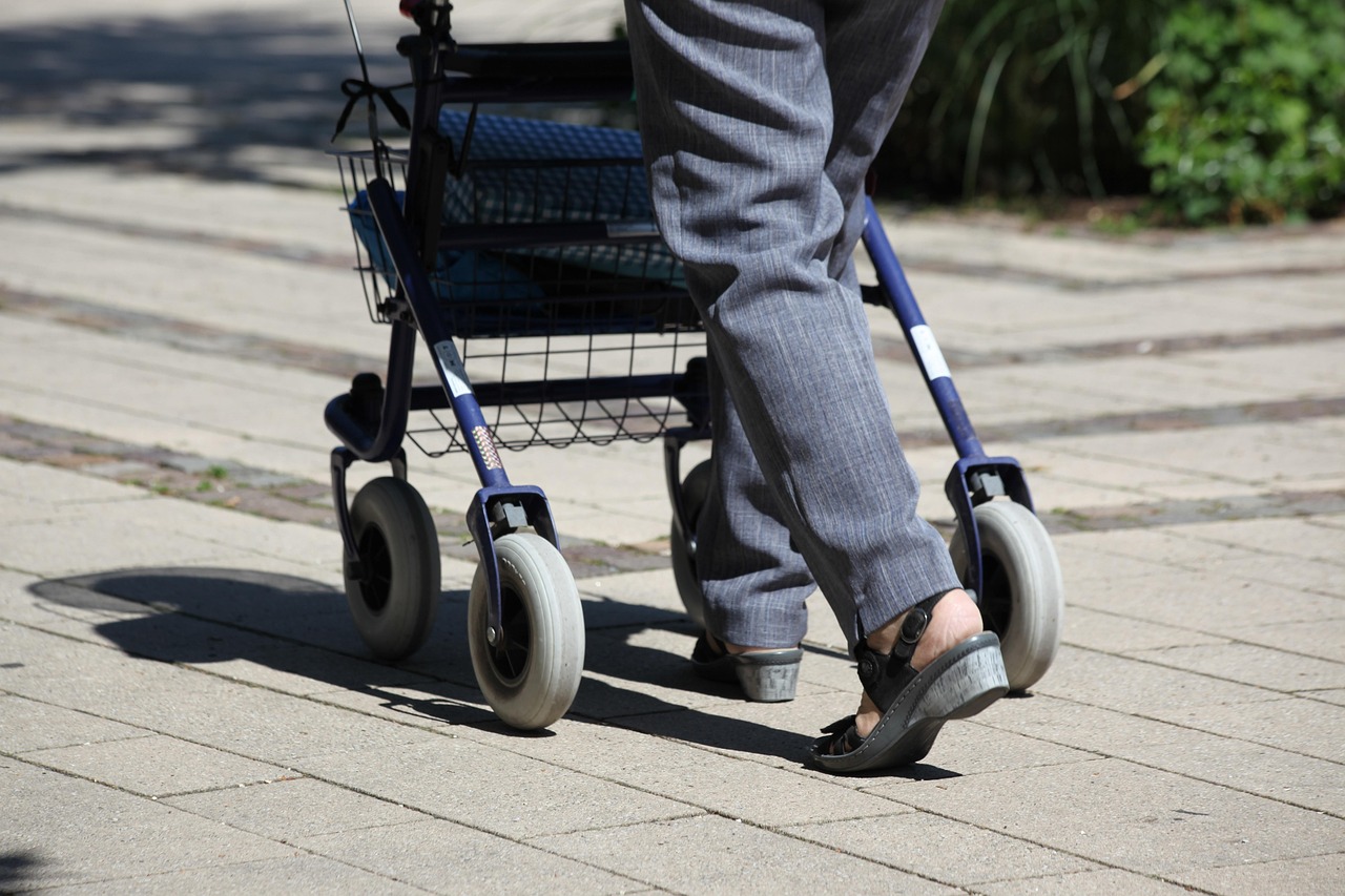 Older person walking using Rollator walker; image by Filmbetrachter, via Pixabay.com.