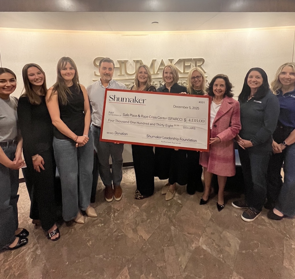 Members of Shumaker and SPARCC with giant check at ceremony; image courtesy of Shumaker.
