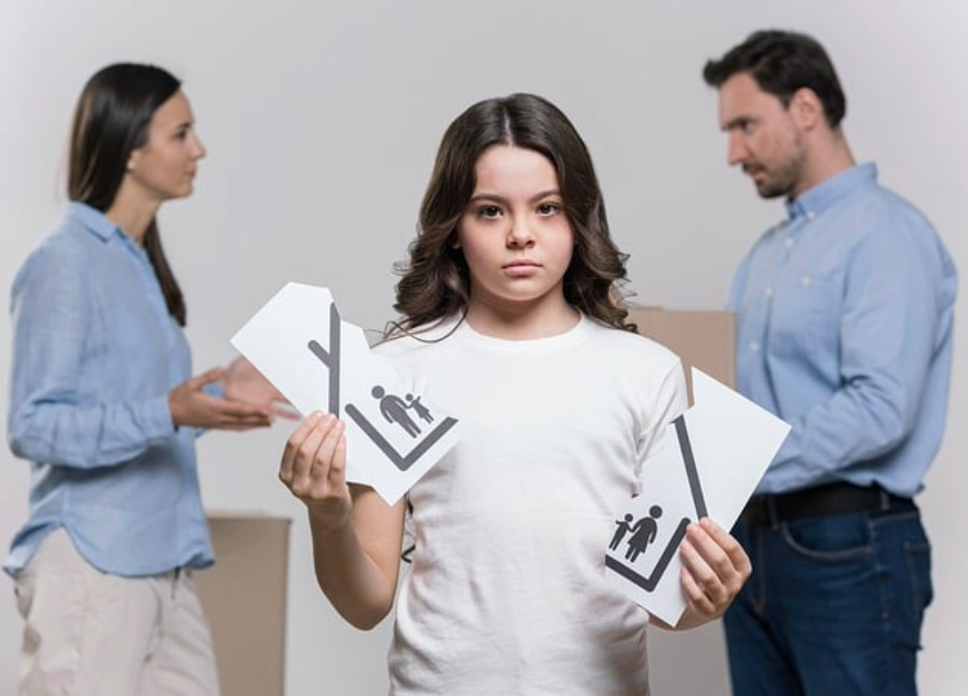 Two parents in background, boy in front holding picture of a home and family torn in half; image by thedivorcelawfirm, via Pixabay.com.
