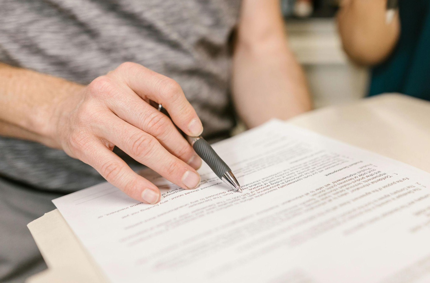 Man reviewing document; image by RDNE Stock project, via Pexels.com.