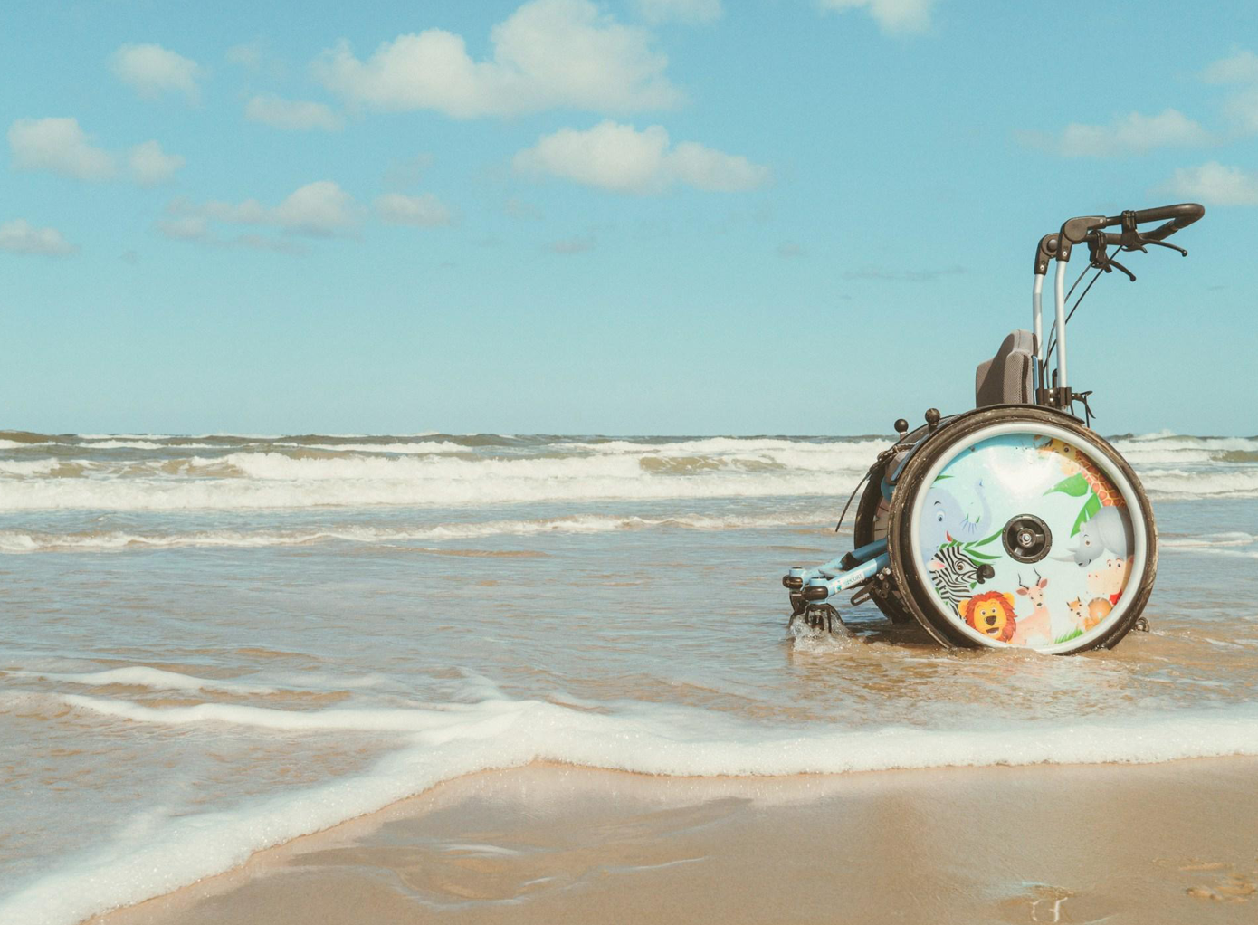 Wheelchair at the beach; image by Jens Theeß, via Unsplash.com.