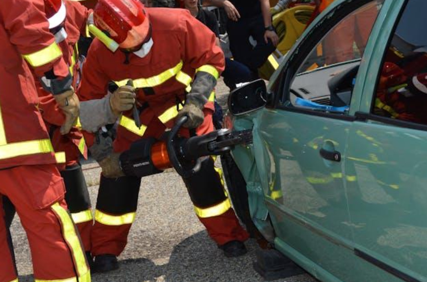 Firefighters showing how they open crashed cars; image by Ulrick Trappschuh, via Pexels.com.