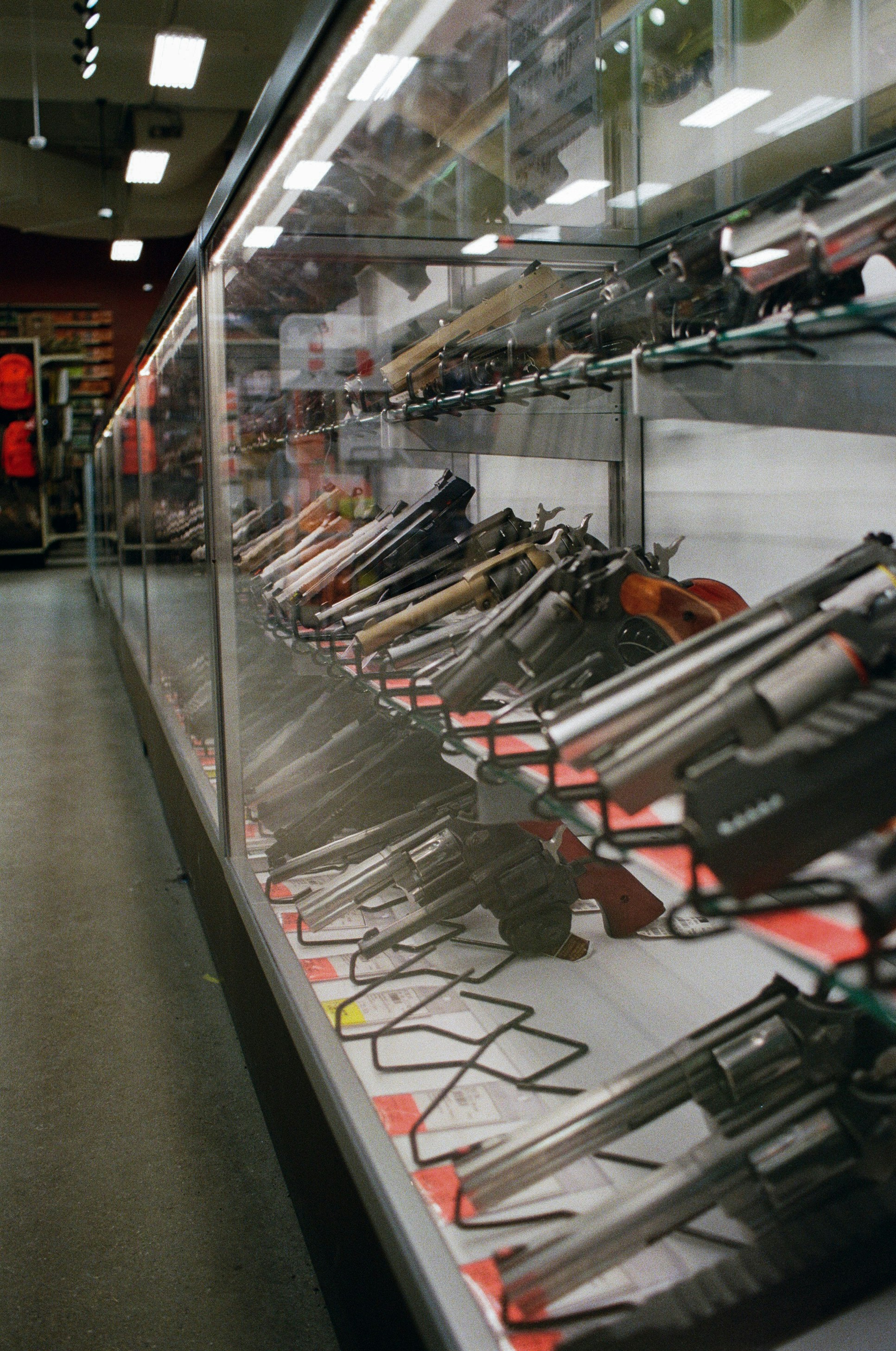 Guns in retail display case; image by Jacob Skowronek, via Unsplash.com.
