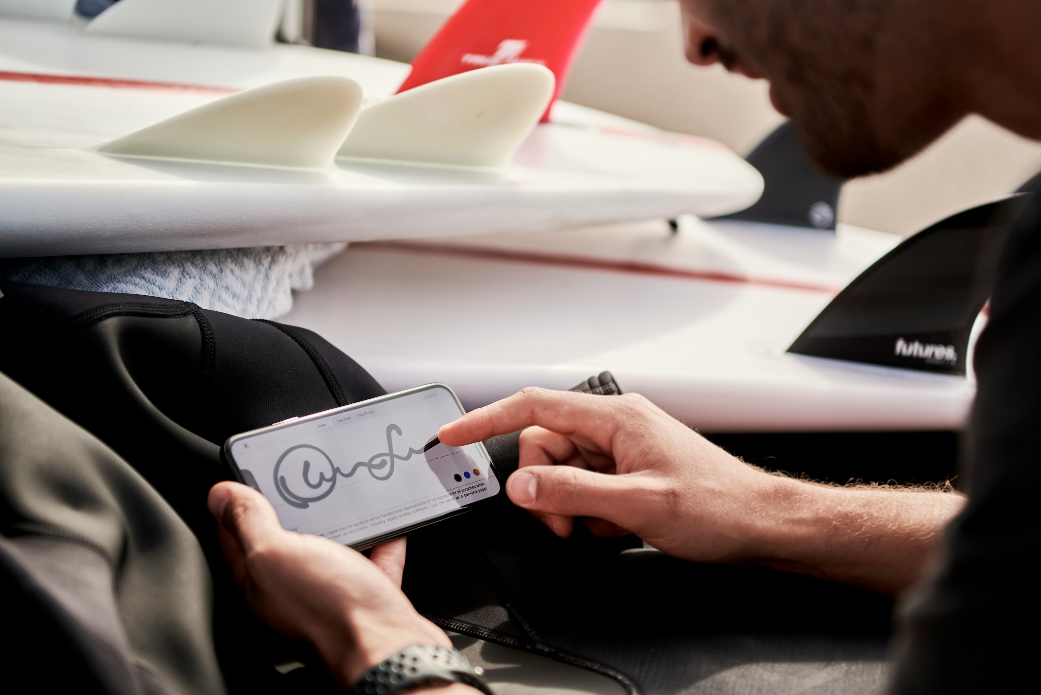 Man working remotely signing contract on DocuSign photo; image by Docusign, via Unsplash.com.