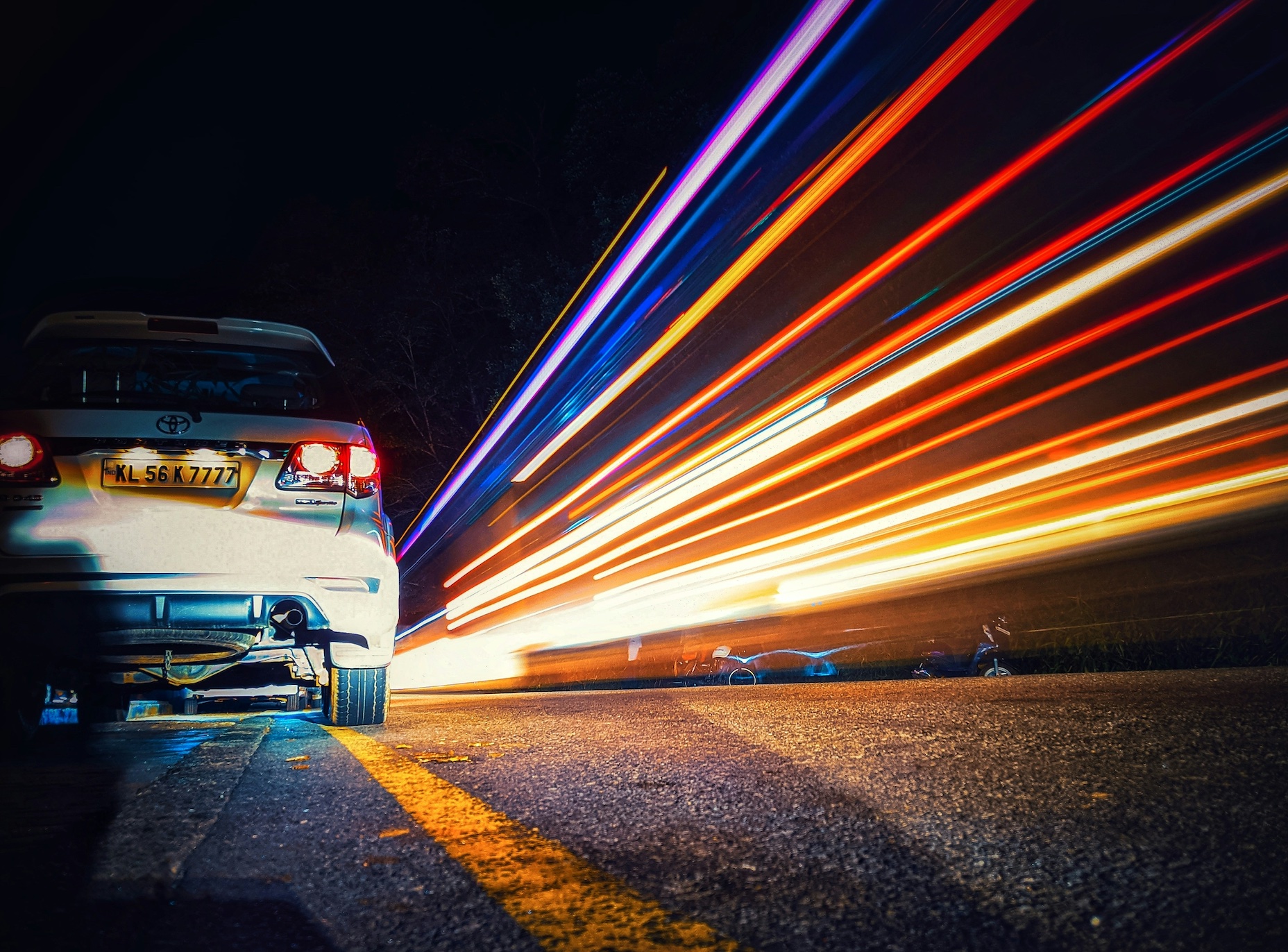 Time lapse photograhpy of vehicle driving away; image by Faris Mohammed, via Unsplash.com.