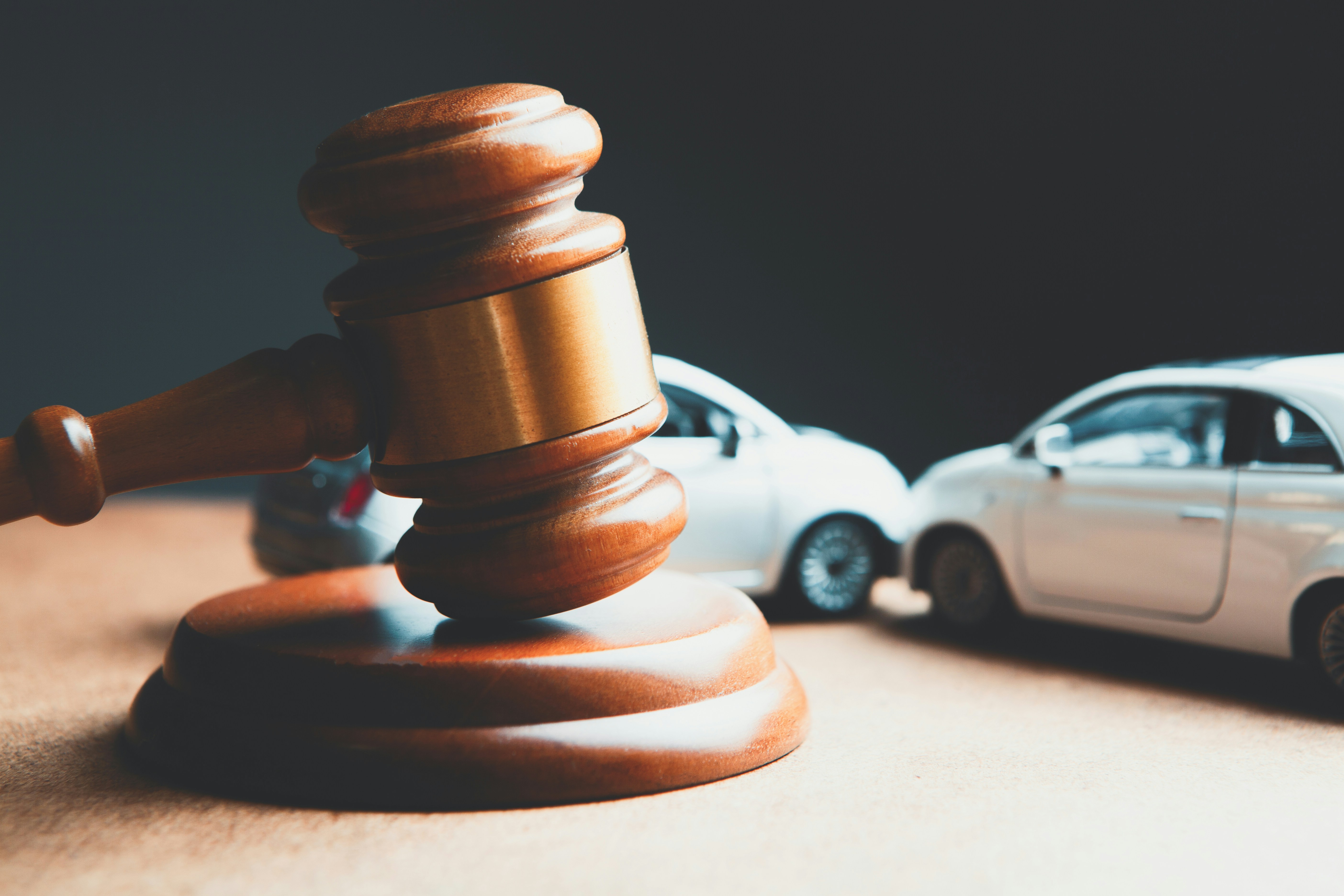 Toy car and wooden gavel on table; image by Sasun Bughdaryan, via Unsplash.com.