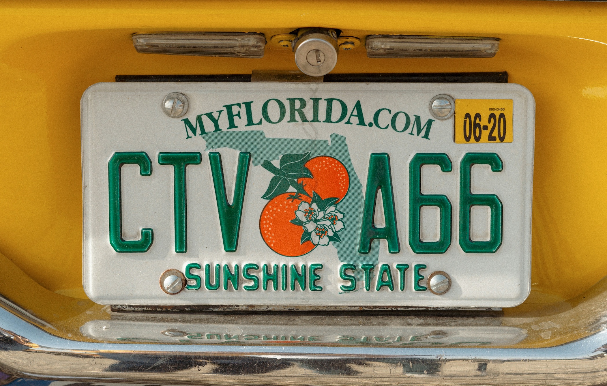 Upclose shot of yellow car with Florida license plates; image by Ed Parker, via Unsplash.com.