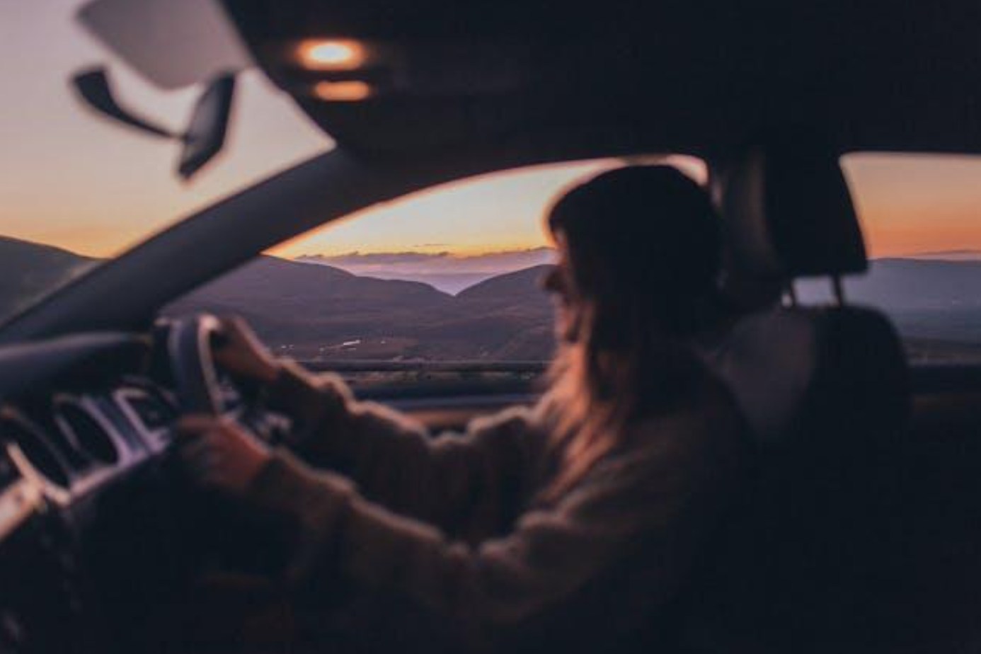 Woman driving car; image by Elina Sazonova, via Pexels.com.