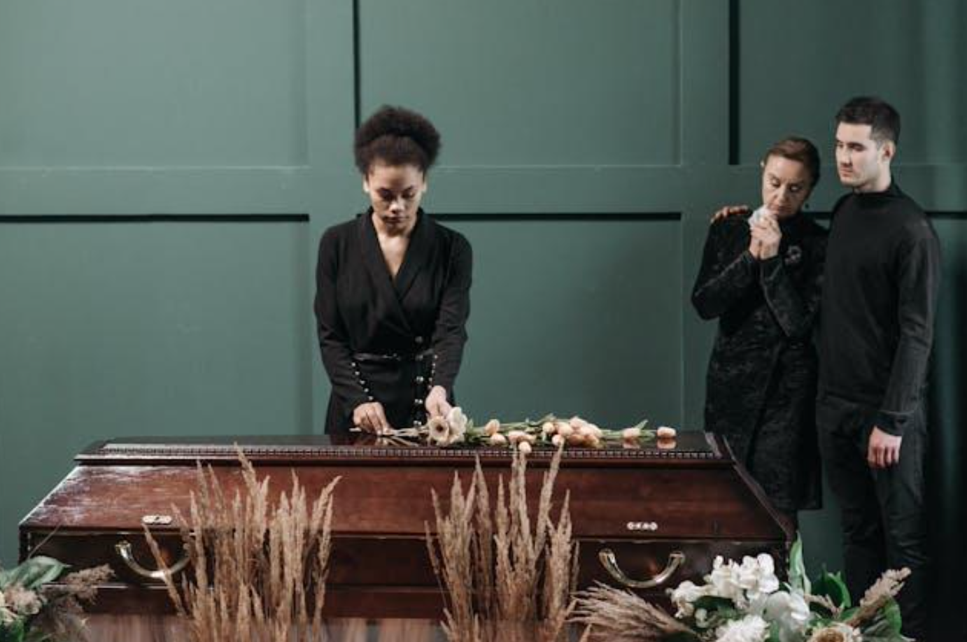 People standing near a coffin; image by Pavel Danilyuk, via Pexels.com.