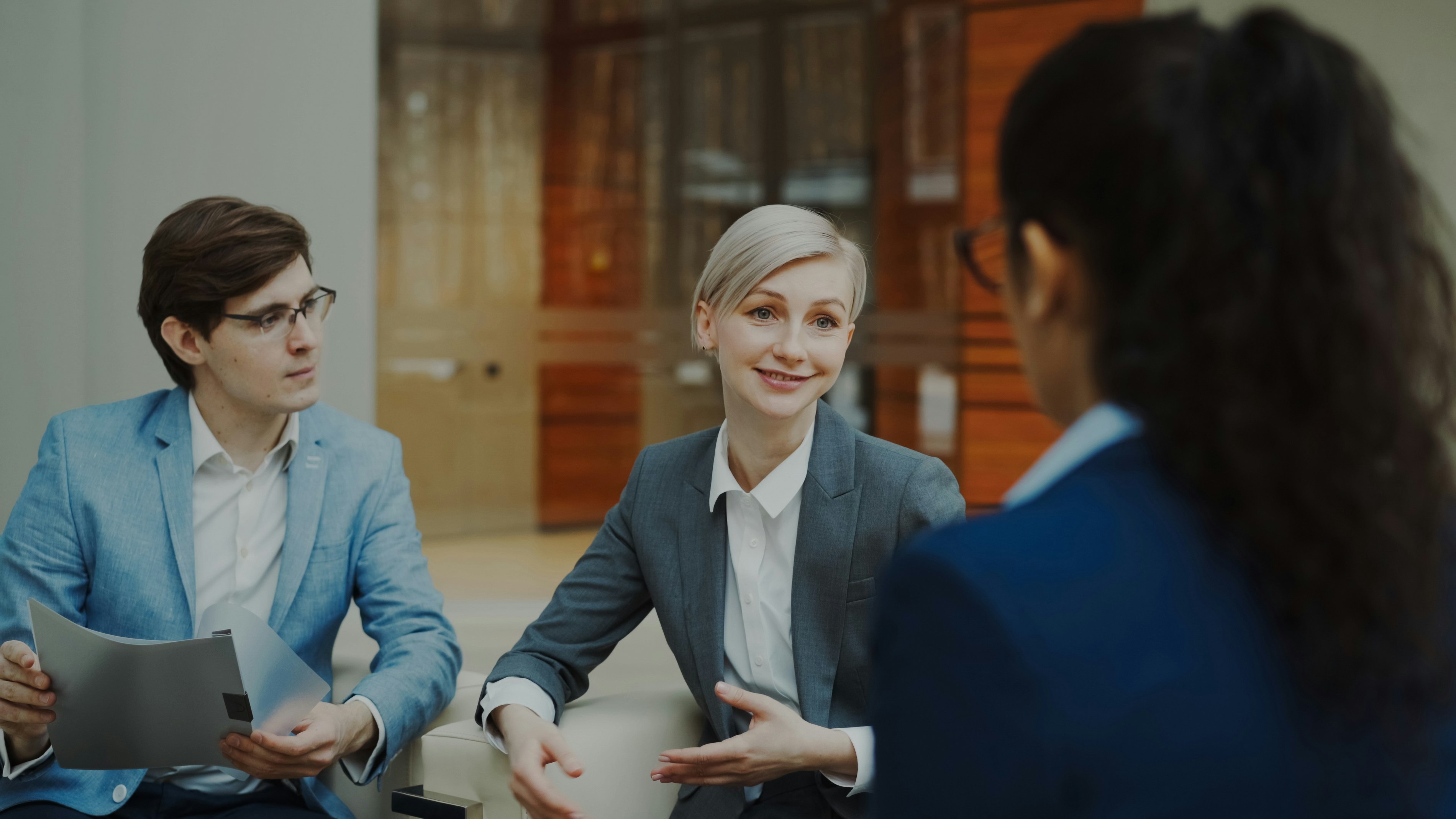 Three people in a meeting; image by Vitaly Gariev, via Unsplash.com.