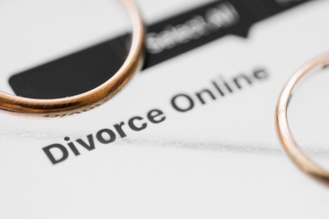 Golden rings on paper that reads divorce online; image by freepik, via Magnific.com.