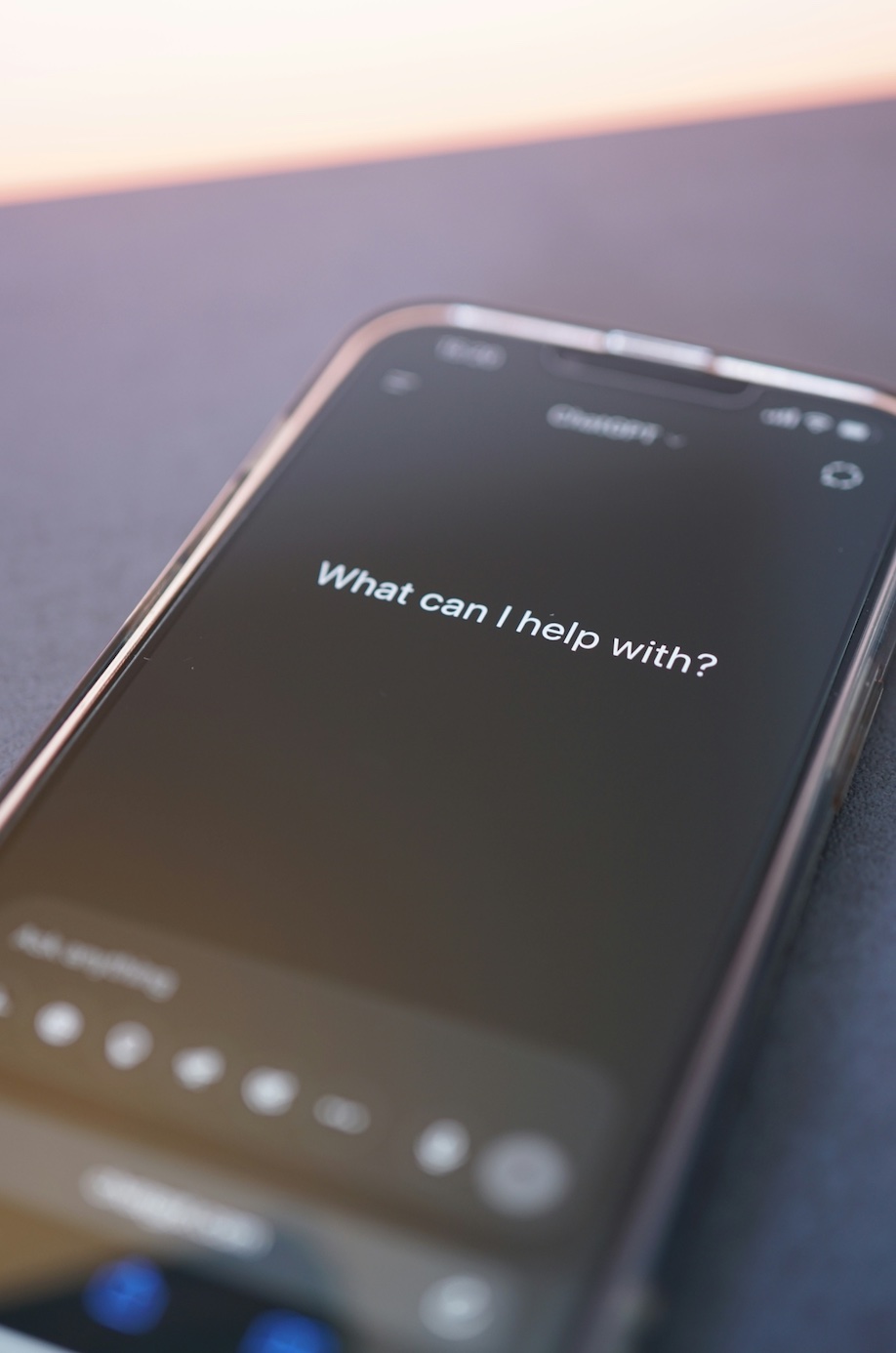 Phone screen asks, What can I help with; image by Tim Witzdam, via Unsplash.com.