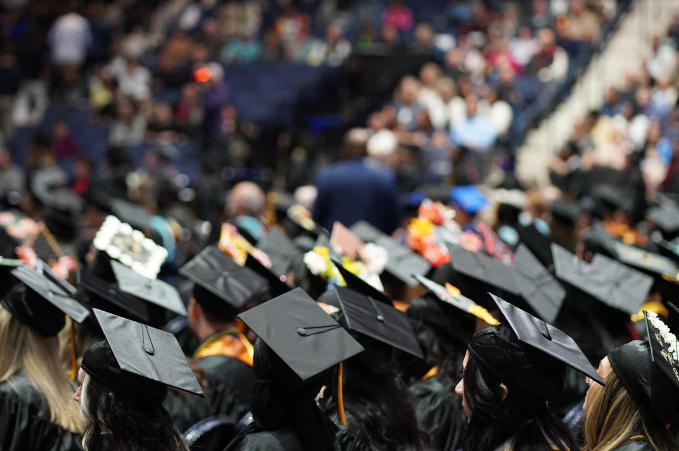 Large group of graduates in caps and gowns; image by Zacqueline Baldwin, via Unsplash.com.