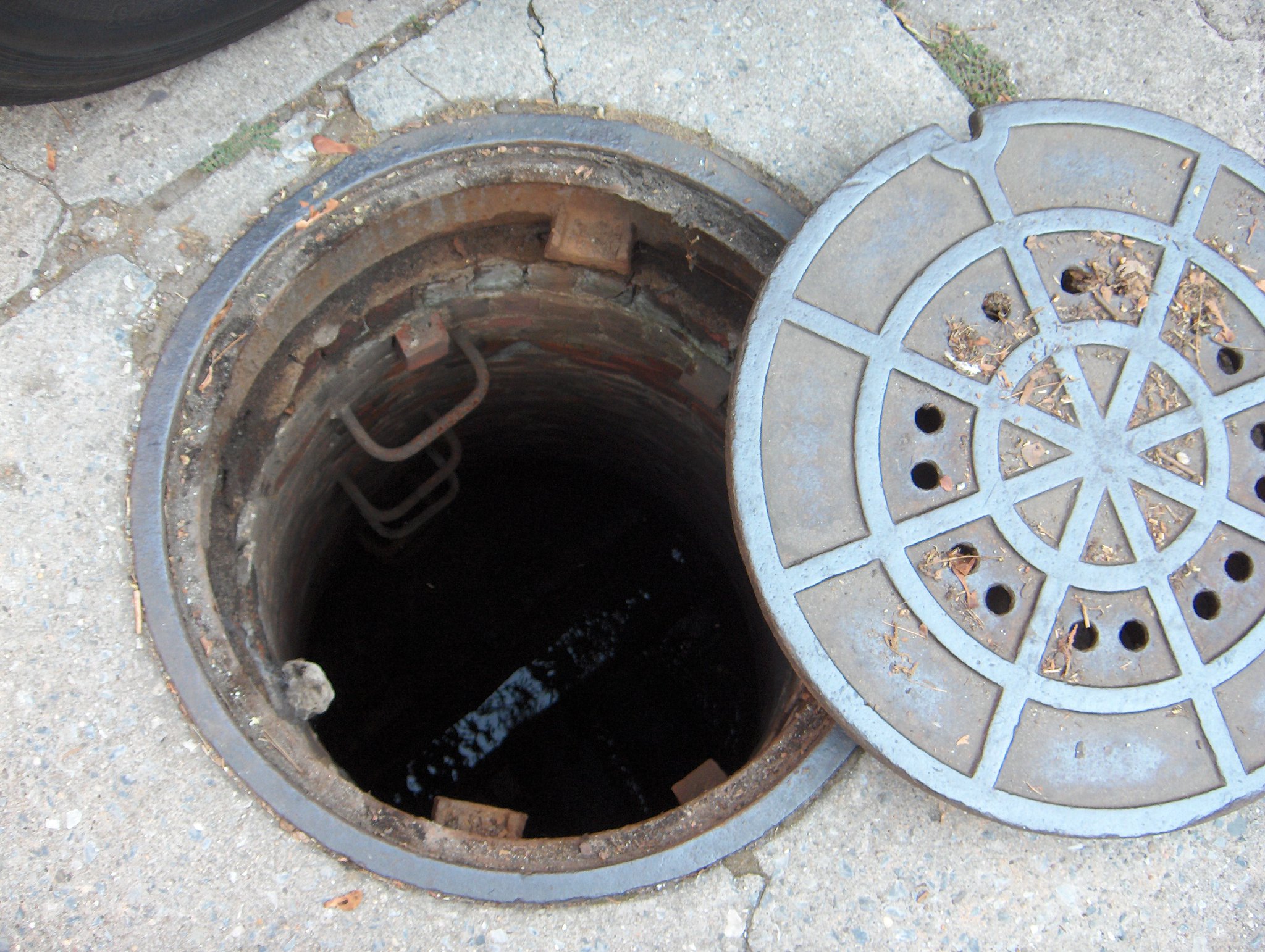 Open manhole with cover; image by Joe Shlabotnik, via Flickr.com, CC BY 2.0.
